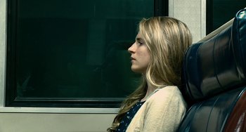 Movie still from “Another Earth” (2011), directed by Mike Cahill – A woman sitting in a chair looking out a window; Close Up shot, Over the shoulder angle