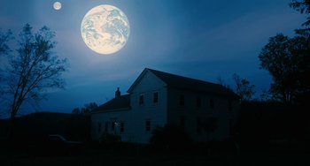 Movie still from “Another Earth” (2011), directed by Mike Cahill – A house with a full moon in the background; Extreme Wide shot, Low angle