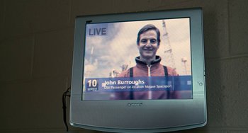 Movie still from “Another Earth” (2011), directed by Mike Cahill – A television screen showing a man on a boat; Close Up shot, Overhead angle