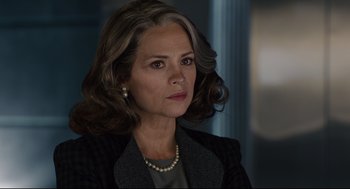 Movie still from “Ant-Man” (2015), directed by Peyton Reed – A person wearing a suit and pearls; Close Up shot, Over the shoulder angle