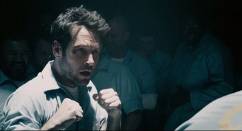 Movie still from “Ant-Man” (2015), directed by Peyton Reed – A man with a surprised look on his face; Close Up shot, Over the shoulder angle