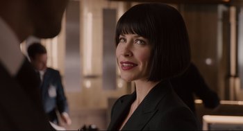 Movie still from “Ant-Man” (2015), directed by Peyton Reed – A woman in a suit smiling for the camera; Close Up shot, Over the shoulder angle