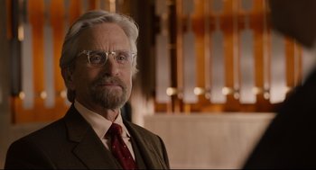 Movie still from “Ant-Man” (2015), directed by Peyton Reed – An older man wearing a suit and tie; Close Up shot, Over the shoulder angle