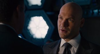 Movie still from “Ant-Man” (2015), directed by Peyton Reed – A man in a suit and tie standing in front of another man in a suit and tie; Close Up shot, Over the shoulder angle