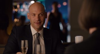 Movie still from “Ant-Man” (2015), directed by Peyton Reed – A man in a suit and tie sitting in front of a glass of wine; Close Up shot, Over the shoulder angle
