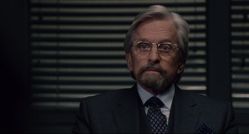 Movie still from “Ant-Man” (2015), directed by Peyton Reed – An older man in a suit and tie; Close Up shot, Over the shoulder angle