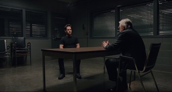 Movie still from “Ant-Man” (2015), directed by Peyton Reed – Two people sitting at a table in a room; Wide shot, Over the shoulder angle