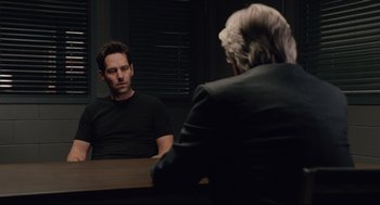Movie still from “Ant-Man” (2015), directed by Peyton Reed – A man sitting in front of another man in front of a mirror; Medium shot, Over the shoulder angle