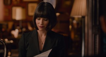Movie still from “Ant-Man” (2015), directed by Peyton Reed – A woman in a black jacket is reading a paper; Close Up shot, Over the shoulder angle