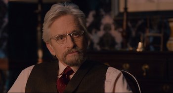 Movie still from “Ant-Man” (2015), directed by Peyton Reed – An older man wearing a suit and tie; Close Up shot, Over the shoulder angle