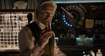 Movie still from “Ant-Man” (2015), directed by Peyton Reed – An old man with a long white beard wearing glasses and holding a red tie; Close Up shot, Over the shoulder angle