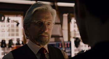 Movie still from “Ant-Man” (2015), directed by Peyton Reed – An older man wearing glasses and a tie; Close Up shot, Over the shoulder angle