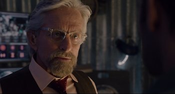 Movie still from “Ant-Man” (2015), directed by Peyton Reed – An older man with a beard and glasses; Close Up shot, Over the shoulder angle