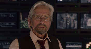 Movie still from “Ant-Man” (2015), directed by Peyton Reed – An old man with a beard and glasses in front of a wall; Close Up shot, Over the shoulder angle