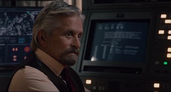 Movie still from “Ant-Man” (2015), directed by Peyton Reed – An older man sitting in front of a computer monitor; Close Up shot, Over the shoulder angle