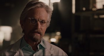 Movie still from “Ant-Man” (2015), directed by Peyton Reed – An older man wearing glasses and a white shirt; Close Up shot, Over the shoulder angle