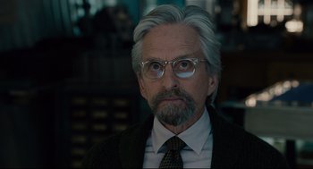 Movie still from “Ant-Man” (2015), directed by Peyton Reed – An older man with grey hair wearing glasses; Close Up shot, Over the shoulder angle