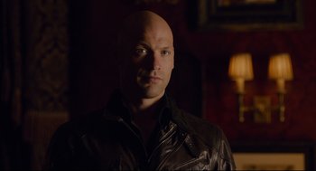 Movie still from “Ant-Man” (2015), directed by Peyton Reed – A bald man in a leather jacket looking at the camera; Close Up shot, Over the shoulder angle