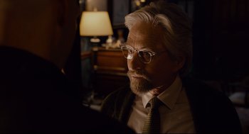 Movie still from “Ant-Man” (2015), directed by Peyton Reed – An older man wearing glasses and a tie; Close Up shot, Over the shoulder angle