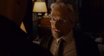 Movie still from “Ant-Man” (2015), directed by Peyton Reed – An older man wearing glasses and a tie; Close Up shot, Over the shoulder angle