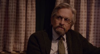 Movie still from “Ant-Man” (2015), directed by Peyton Reed – An older man wearing a suit and tie; Close Up shot, Over the shoulder angle