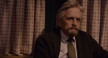 Movie still from “Ant-Man” (2015), directed by Peyton Reed – An older man wearing a suit and tie; Close Up shot, Over the shoulder angle