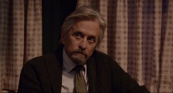 Movie still from “Ant-Man” (2015), directed by Peyton Reed – An older man wearing a suit and a tie; Close Up shot, Over the shoulder angle