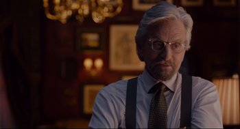 Movie still from “Ant-Man” (2015), directed by Peyton Reed – An older man wearing a suit and tie; Close Up shot, Over the shoulder angle