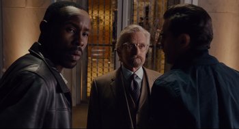 Movie still from “Ant-Man” (2015), directed by Peyton Reed – A group of men standing next to each other in a room; Medium shot, Over the shoulder angle