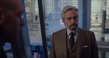 Movie still from “Ant-Man” (2015), directed by Peyton Reed – An older man wearing a suit and tie; Close Up shot, Over the shoulder angle
