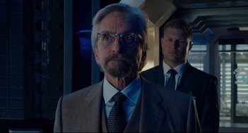 Movie still from “Ant-Man” (2015), directed by Peyton Reed – A man in a suit and tie standing next to another man in a suit and tie; Close Up shot, Low angle