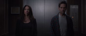 Movie still from “Ant-Man and the Wasp” (2018), directed by Peyton Reed – A woman and a man standing next to each other in front of an elevator; Medium shot, Low angle