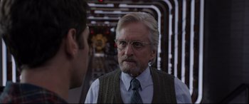 Movie still from “Ant-Man and the Wasp” (2018), directed by Peyton Reed – An older man wearing glasses and a sweater vest; Close Up shot, Over the shoulder angle