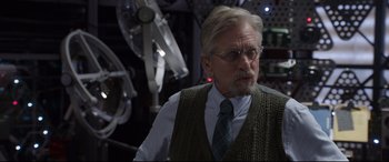 Movie still from “Ant-Man and the Wasp” (2018), directed by Peyton Reed – An older man wearing glasses and a sweater vest; Close Up shot, Over the shoulder angle