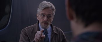 Movie still from “Ant-Man and the Wasp” (2018), directed by Peyton Reed – An older man wearing glasses and a tie; Close Up shot, Over the shoulder angle
