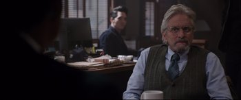Movie still from “Ant-Man and the Wasp” (2018), directed by Peyton Reed – A man sitting at a desk in front of a computer; Medium shot, Over the shoulder angle
