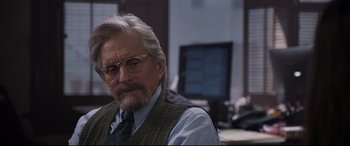 Movie still from “Ant-Man and the Wasp” (2018), directed by Peyton Reed – An older man wearing glasses and a sweater vest; Close Up shot, Over the shoulder angle