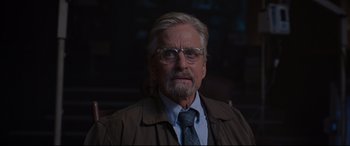 Movie still from “Ant-Man and the Wasp” (2018), directed by Peyton Reed – An older man wearing glasses and wearing a tie; Close Up shot, Over the shoulder angle