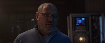 Movie still from “Ant-Man and the Wasp” (2018), directed by Peyton Reed – An older man wearing glasses and a blue sweater; Close Up shot, Low angle