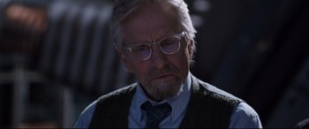 Movie still from “Ant-Man and the Wasp” (2018), directed by Peyton Reed – An older man wearing glasses and wearing a sweater vest; Close Up shot, Over the shoulder angle
