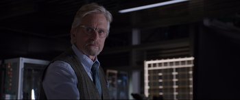 Movie still from “Ant-Man and the Wasp” (2018), directed by Peyton Reed – An older man wearing glasses and a sweater vest; Close Up shot, Over the shoulder angle