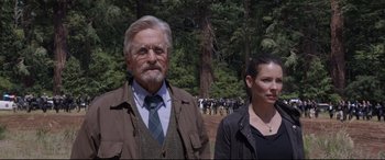 Movie still from “Ant-Man and the Wasp” (2018), directed by Peyton Reed – An older man and a younger woman standing next to each other in front of a forest; Medium shot, Over the shoulder angle