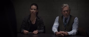 Movie still from “Ant-Man and the Wasp” (2018), directed by Peyton Reed – Two people sitting at a table in front of a brick wall; Medium shot, Over the shoulder angle