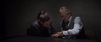 Movie still from “Ant-Man and the Wasp” (2018), directed by Peyton Reed – A man and a woman sitting at a table looking at a cell phone; Medium shot, High angle