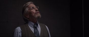 Movie still from “Ant-Man and the Wasp” (2018), directed by Peyton Reed – An older man wearing glasses and a sweater vest; Close Up shot, Low angle