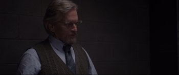 Movie still from “Ant-Man and the Wasp” (2018), directed by Peyton Reed – An older man wearing glasses and wearing a sweater vest; Close Up shot, Over the shoulder angle