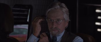 Movie still from “Ant-Man and the Wasp” (2018), directed by Peyton Reed – An older man with a beard and glasses is holding a cell phone; Close Up shot, Over the shoulder angle