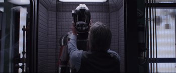 Movie still from “Ant-Man and the Wasp” (2018), directed by Peyton Reed – A person holding a helmet in a room; Medium shot, Over the shoulder angle