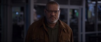 Movie still from “Ant-Man and the Wasp” (2018), directed by Peyton Reed – A man with a beard wearing glasses and a brown jacket; Close Up shot, Low angle