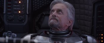 Movie still from “Ant-Man and the Wasp” (2018), directed by Peyton Reed – An older man with a gray beard wearing a space suit; Close Up shot, Low angle